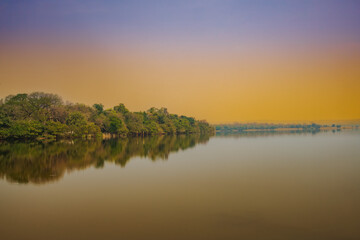 A wide angle shot of natures reflection on the lake, this lake is called Pakhal lake, located in Warangal, Telangana State, India
