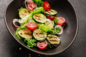 Salad grilled zucchini, tomato, lettuce tasty snack fresh delicious gourmet food background on the table rustic food top view copy space keto and paleo diet vegan and vegetarian food