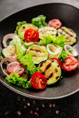 Salad grilled zucchini, tomato, lettuce tasty snack fresh delicious gourmet food background on the table rustic food top view copy space keto and paleo diet vegan and vegetarian food