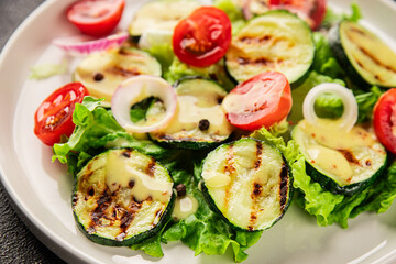 Salad grilled zucchini, tomato, lettuce tasty snack fresh delicious gourmet food background on the table rustic food top view copy space keto and paleo diet vegan and vegetarian food