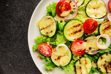 Salad grilled zucchini, tomato, lettuce tasty snack fresh delicious gourmet food background on the table rustic food top view copy space keto and paleo diet vegan and vegetarian food
