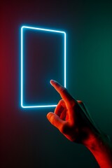 Hand touching a glowing neon frame in the dark