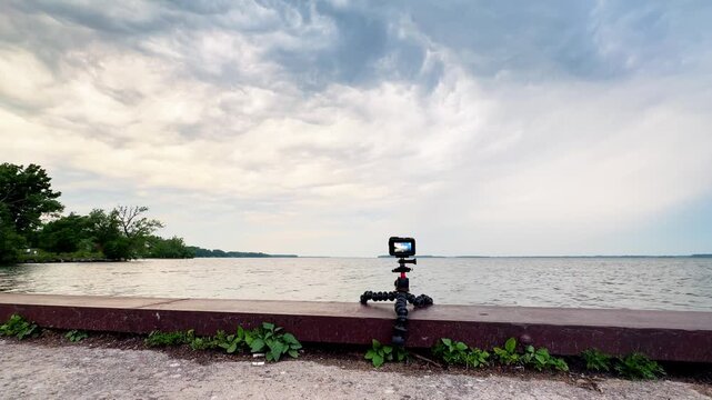 Action camera set up on a dock in Orillia, Ontario, capturing storm clouds rolling over a lake