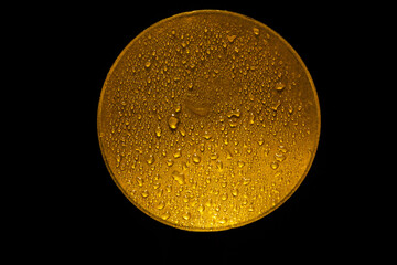 water drops on a gold metal disk  