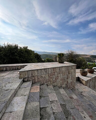 Stone stairs and terrace with scenic mountain view under blue sky