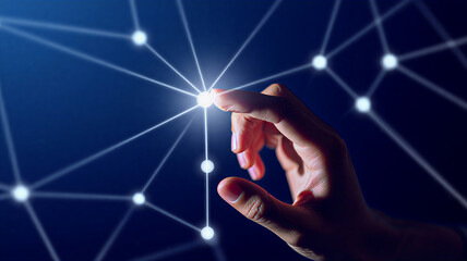 Hand Touching a Glowing Node in a Digital Network