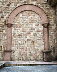Stone arch on rustic brick wall