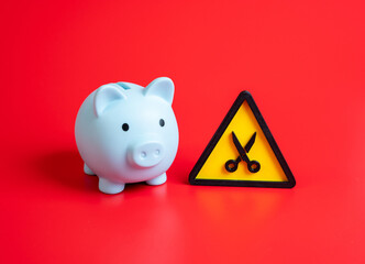 The budget is subject to cuts. Reduction of income and household savings. Concept of austerity, economic crisis, financial stress, and corporate downsizing.