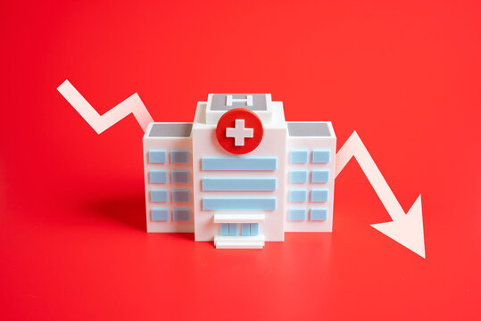 Hospital with down arrow. Symbol of reduced healthcare access, medical closures, and budget shortages. Suitable for health reform, crisis, and social policy themes.