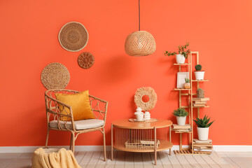 Interior of living room with shelving unit, wicker armchair and table