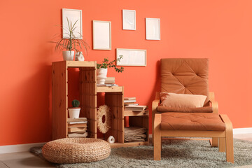 Interior of living room with shelving unit, pouf, armchair and ottoman