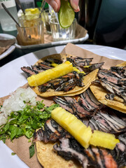 Gourmet black pastor tacos with pineapple and lime squeeze