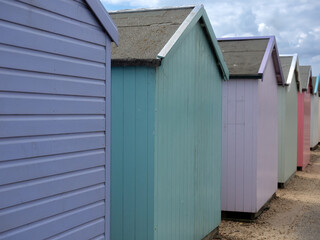 Rear view of colourful painted wooden beach huts