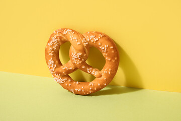Tasty pretzel on color background, closeup