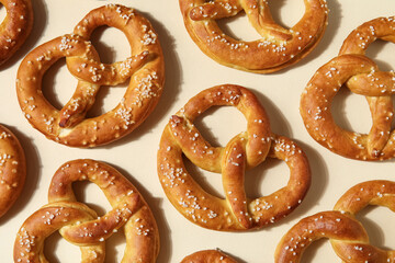 Composition with tasty pretzels on beige background, closeup