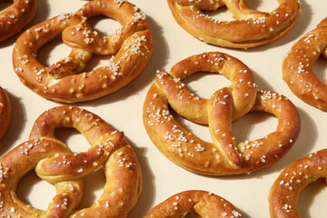 Composition with tasty pretzels on beige background, closeup