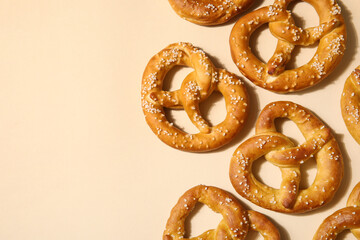 Composition with tasty pretzels on beige background, closeup