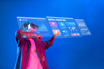 A person wearing virtual reality goggles interacts with holographic displays showcasing data analytics and marketing strategies for social media advertisements in a dynamic environment. XDMCP