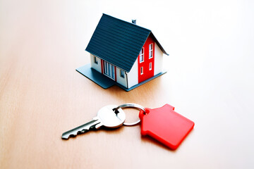 Miniature house model and red house shaped keychain with silver key image