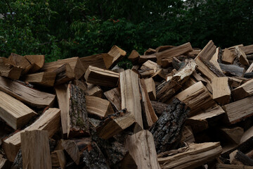 Freshly chopped wooden firewood neatly stacked for storage. Natural timber prepared for heating, fireplace, stove or campfire use. Eco-friendly fuel and renewable energy source.