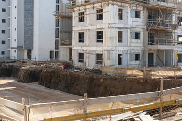 onstruction site in Israel shows a multi-story concrete building in progress. Excavated ground highlights active structural development
