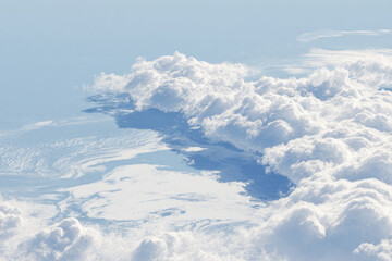 aerial view of ocean surface captures beauty of thin layers of clouds drifting above