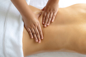Closeup woman customer enjoying relaxing anti-stress spa massage and pampering with beauty skin...