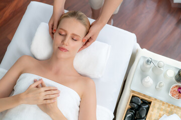 Panorama top view of woman enjoying relaxing anti-stress head massage and pampering facial beauty...