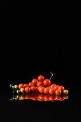Cherry Tomatoes with Glossy Reflection on Black Background