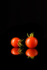 Juicy Red Tomatoes on Dark Reflective Surface &ndash; Minimalist Food Concept