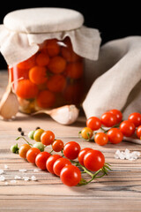 Pickled and Fresh Tomatoes on Natural Linen and Wooden Surface &ndash; Black Background
