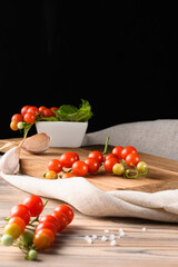 Fresh Tomatoes Resting on Rustic Wood and Linen in Dark Minimalist Setting