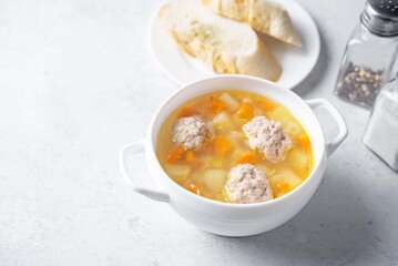 Potato soup with meatballs in a bowl