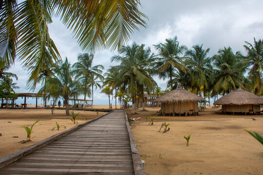 Wooden walkway and traditional huts on San Pedro beach, Ivory Coast