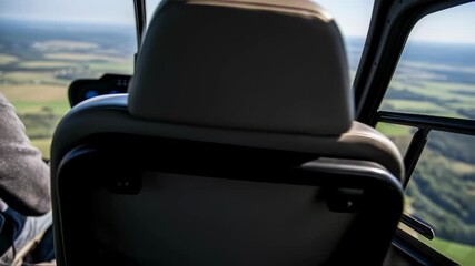 Man flying helicopter observing aerial landscape, pilot view from cockpit, scenic river winding through fields footage. - Powered by Adobe