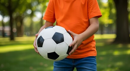Close-up of child playing with soccer ball, joyful outdoor activity and energetic moment clearly shown.