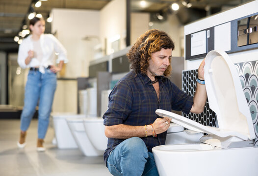 Man looking to buy new toilet in harware store