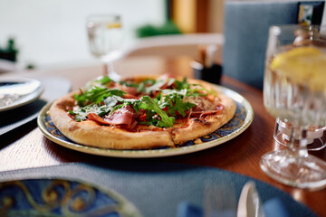 Served pizza prosciutto in a restaurant.