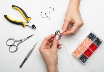 Creative hands making beaded jewelry with craft tools.