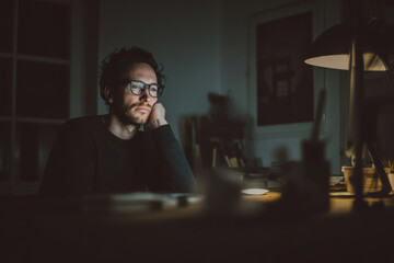 man sitting at his desk in home office engaged in cryptocurrency trading with augmented trading panel