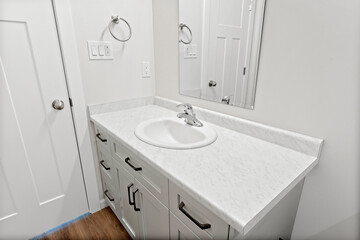 Bathroom with a white sink and a white mirror