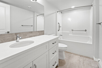 Bathroom with a white sink, toilet, and bathtub