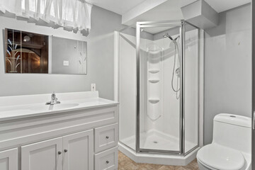 Bathroom with a white toilet, sink, and shower