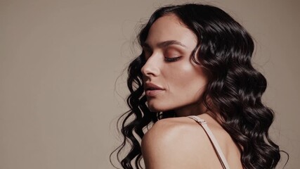 Model showcases elegant hairstyle and makeup during studio session in spacious setting with soft lighting