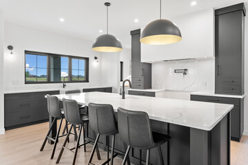 Kitchen with a large island and black chairs