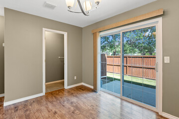 Large open living room with a wooden floor and a sliding glass door