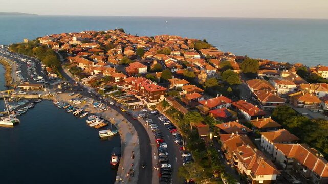Aerial view of old mill, road and the center of old Nessebar, houses, churches. Drone view from above. Summer holidays destination
