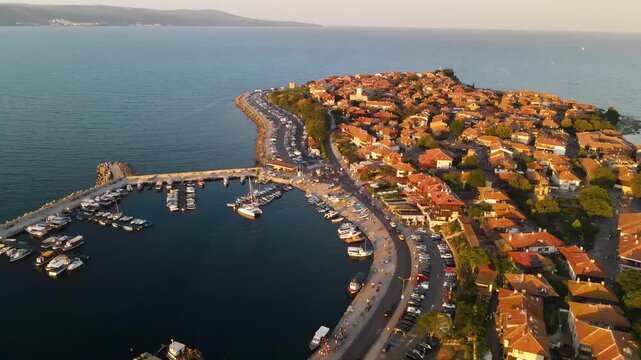 Aerial view of old mill, road and the center of old Nessebar, houses, churches. Drone view from above. Summer holidays destination
