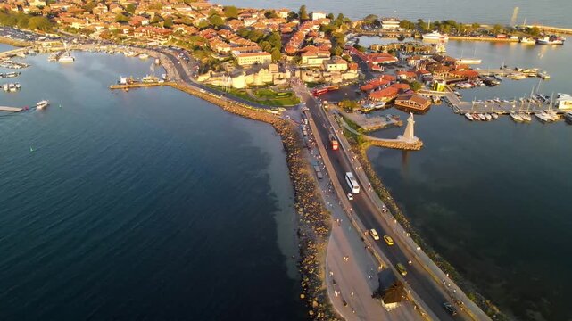 Aerial view of old mill, road and the center of old Nessebar, houses, churches. Drone view from above. Summer holidays destination
