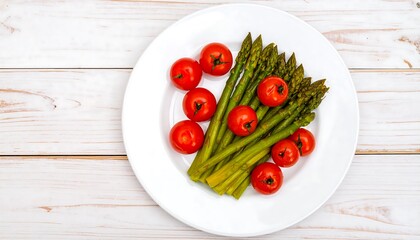 Fresh asparagus and cherry tomatoes on a white plate